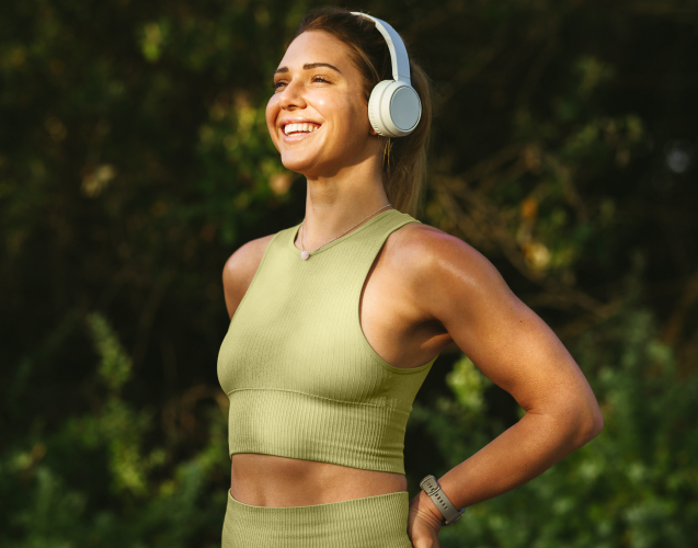A smiling woman in earphones