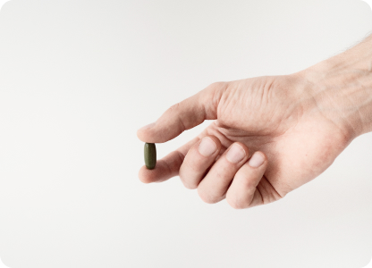 A capsule being help between thumb and a forefinger