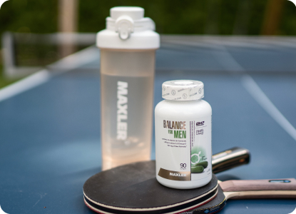 A Balance for Men bottle and a shaker on the table tennis table