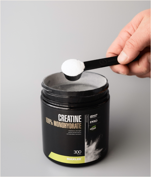 Creatine 100% Monohydrate can with a scoop being taken out of it