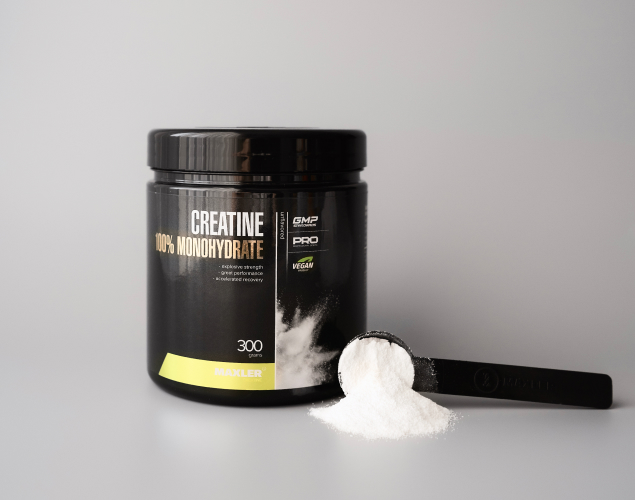 Creatine 100% Monohydrate can and a scoop with powder