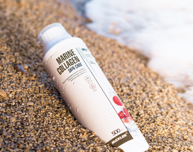 Marine Collagen Skin Care Strawberry 500ml bottle lying in the sand