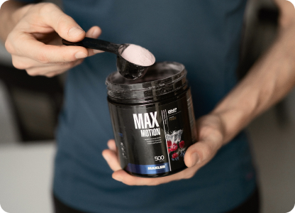 A scoop of Max Motion being taken out of a can