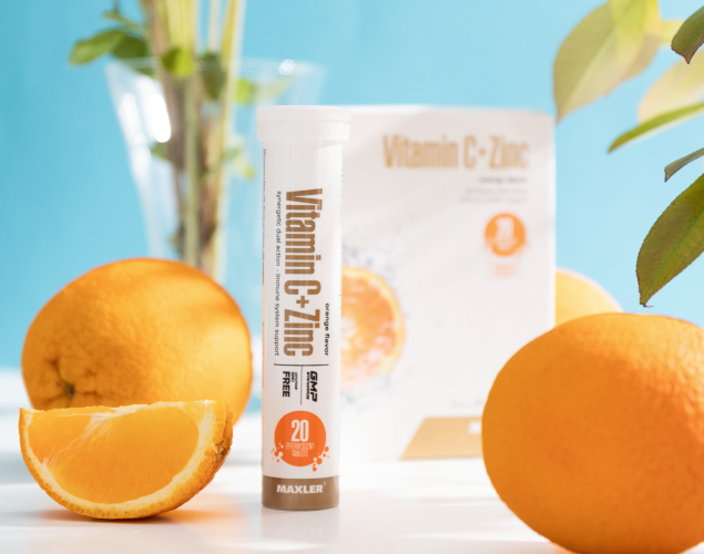 Vitamin C + Zinc Effervescent Tablets box, tube and some oranges