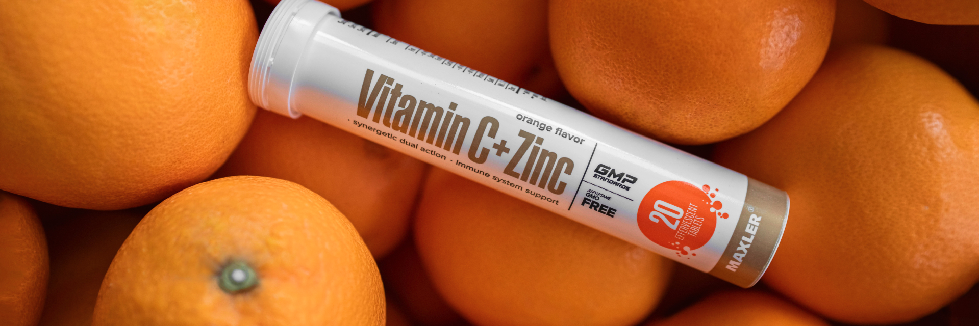 Vitamin C + Zinc Effervescent Tablets tube and some oranges